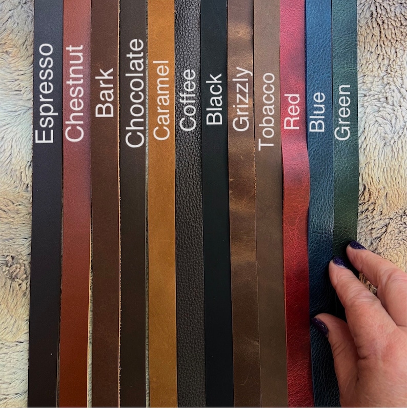 May include: A collection of leather strips in various colors, including Espresso, Chestnut, Bark, Chocolate, Caramel, Coffee, Black, Grizzly, Tobacco, Red, Blue, and Green. Each strip is labeled with its corresponding color name in white text. The image showcases a range of leather textures and hues.