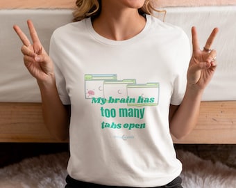 May include: White t-shirt with a green and blue graphic of computer tabs and the text "My brain has too many tabs open".