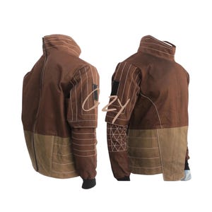 May include: A brown jacket with a high collar and a two-tone design. The upper portion is a darker brown, while the lower section is a lighter tan. White stitching details the seams and sleeves. A black patch is on the upper arm.