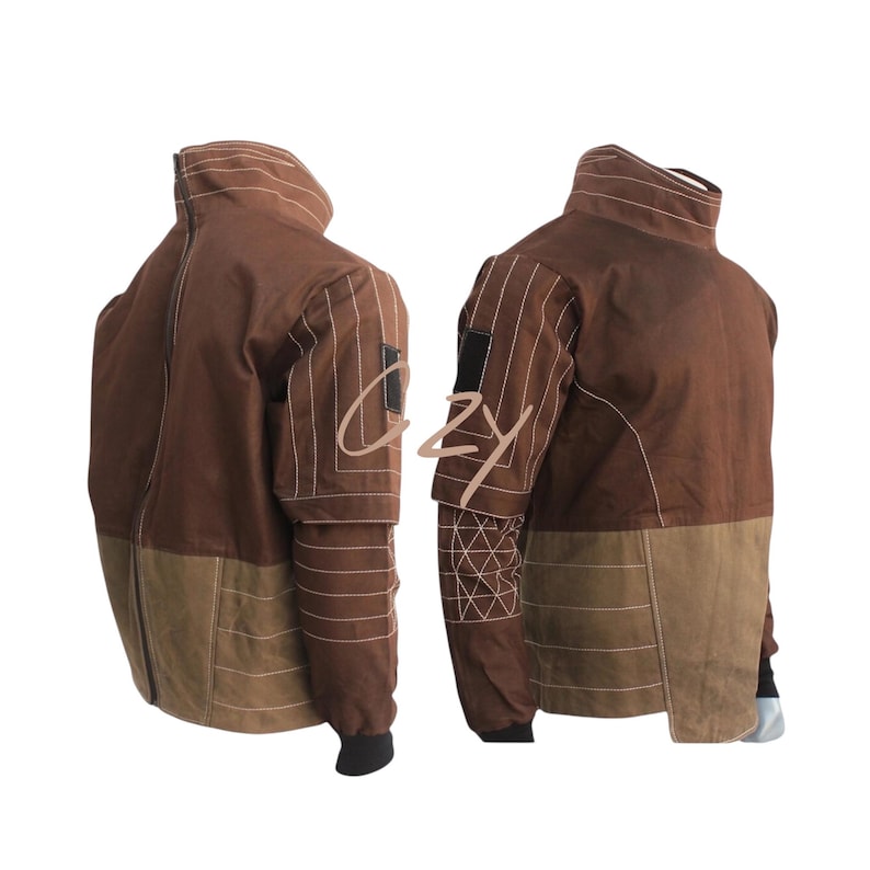 May include: A brown jacket with a high collar and a two-tone design. The upper portion is a darker brown, while the lower section is a lighter tan. White stitching details the seams and sleeves. A black patch is on the upper arm.