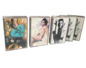 May include: Four cassette tapes featuring Prince. The first tape is a double album titled "Sign o' the Times" with a blue heart graphic. The other three tapes feature black and white images of Prince.