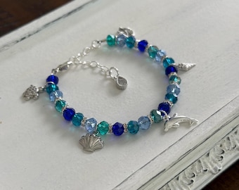 Ocean theme multi charm with sparkly mix blue glass crystal beads .925 Sterling Silver bracelet; dolphin, shells, turtle, anchor charms