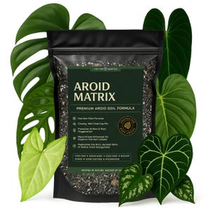 May include: A black bag of Aroid Matrix premium soil formula, surrounded by various green tropical leaves. The label features the text "AROID MATRIX" and details about the soil's nutrient-rich, well-draining properties, and its ability to promote airflow and root oxygenation.