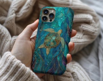 May include: A smartphone case featuring a stained glass style design of a sea turtle swimming among aquatic plants. The artwork uses shades of teal, blue, and purple with gold outlines, creating a mosaic effect across the entire back surface.