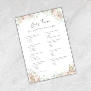 May include: A baby trivia game sheet with floral and bunny illustrations. The text reads "Baby Trivia" and "Test your baby knowledge" with multiple-choice questions about babies. The sheet is decorated with soft colours.