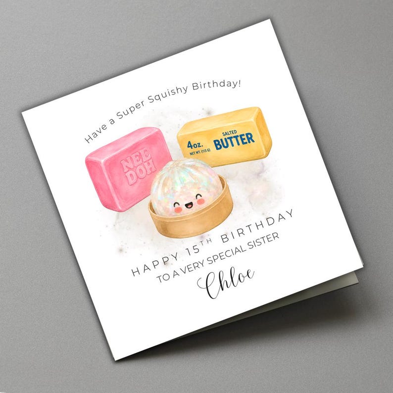 May include: A square greeting card featuring a watercolour illustration of a pink Nee Doh block, a yellow 113g salted butter stick, and a small smiling dumpling in a bamboo steamer. Text reads: Have a Super Squishy Birthday! HAPPY 15TH BIRTHDAY TO A VERY SPECIAL SISTER Chloe.