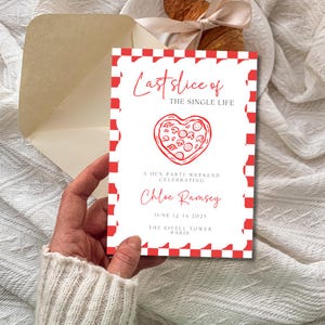 May include: A white invitation card with a red checkered border and the text "Last Slice of The Single Life". The card features a heart-shaped pizza illustration and event details, held in a hand.