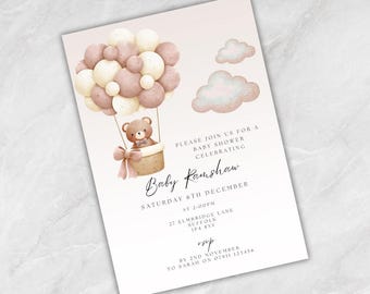 May include: Baby shower invitation featuring a teddy bear in a hot air balloon made of balloons in shades of brown and cream. The invitation includes the text "Baby Ramshaw" and event details, with a soft pink and white background.