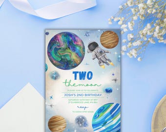 May include: A birthday invitation with a space theme. The invitation features a colorful planet, an astronaut, and the text "TWO the moon." Additional planets and stars are scattered around the design. The invitation includes the birthday details.