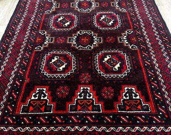 May include: A dark red and black rug with a geometric pattern. The rug has a white fringe border.