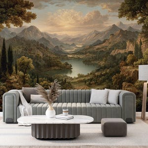 May include: A living room scene featuring a gray sofa, a white marble coffee table, and a matching ottoman. The backdrop is a large mural depicting a scenic landscape with mountains, a lake, and trees. A floor lamp with a white shade stands to the right.