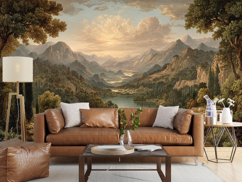 May include: A living room scene featuring a large landscape mural of mountains, a lake, and a sunset. A brown leather sofa with pillows is in front of the mural. A floor lamp, coffee table, and side table complete the room's decor.