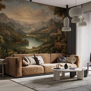 May include: A modern living room featuring a large landscape mural, a brown sectional sofa with decorative pillows, and a round coffee table. A large cactus in a pot sits on a wooden side table. The room is illuminated by pendant lights.