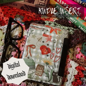 May include: A Kindle Insert with a whimsical design featuring strawberries, keys, hearts, and a black cat. The insert has a gray and white checkered pattern and the words "KINDLE INSERT" and "digital download".