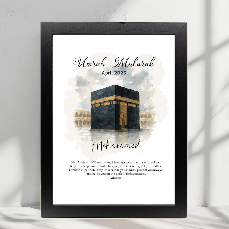 May include: A watercolor illustration of the Kaaba in Mecca, Saudi Arabia. The image is in a black frame and includes the text "Umrah Mubarak April 2025" and "Mohammed". The text below the image reads "May Allah's (SWT) mercy and blessings continue to surround you. May He accept your efforts, forgive your sins, and grant you endless barakah in your life. May He increase you in faith, protect you always, and guide you on the path of righteousness. Ameen."