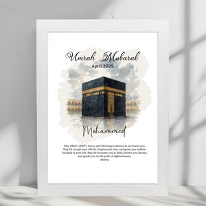 May include: A watercolor illustration of the Kaaba in Mecca, Saudi Arabia. The image is in shades of gray and gold with a white background. The text "Umrah Mubarak" and "April 2025" is at the top of the image. The text "Mohammed" is below the image of the Kaaba. The text "May Allah's (SWT) mercy and blessings continue to surround you. May He accept your efforts, forgive your sins, and grant you endless barakah in your life. May He increase you in faith, protect you always, and guide you on the path of righteousness. Ameen" is at the bottom of the image.