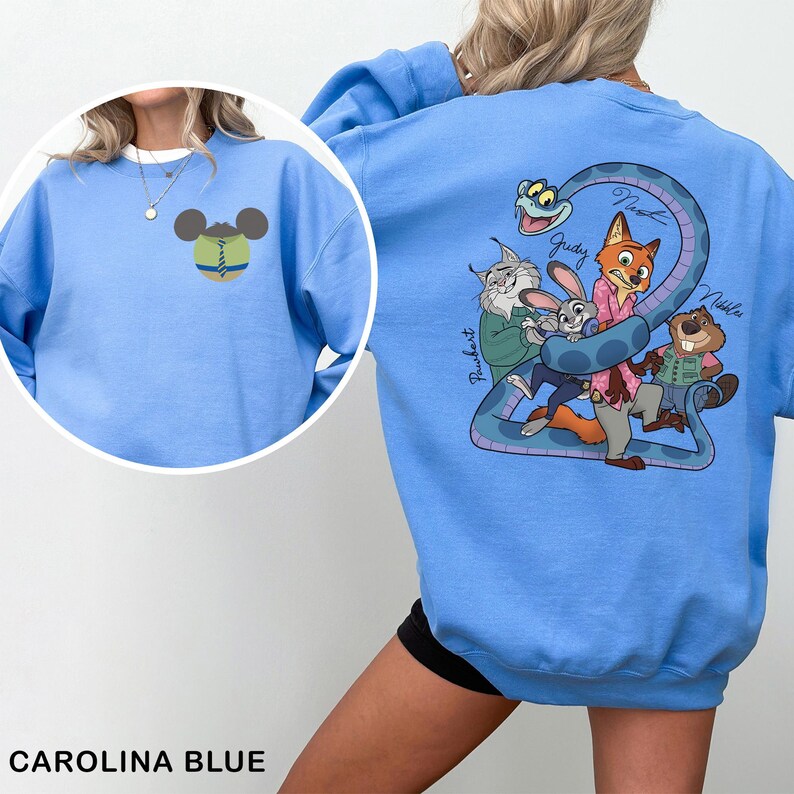 May include: Carolina blue sweatshirt featuring a cartoon design on the front and back. The front has a Mickey Mouse-inspired design. The back features a cartoon snake and several animal characters. The text "Judy" and "Nibbles" are visible.