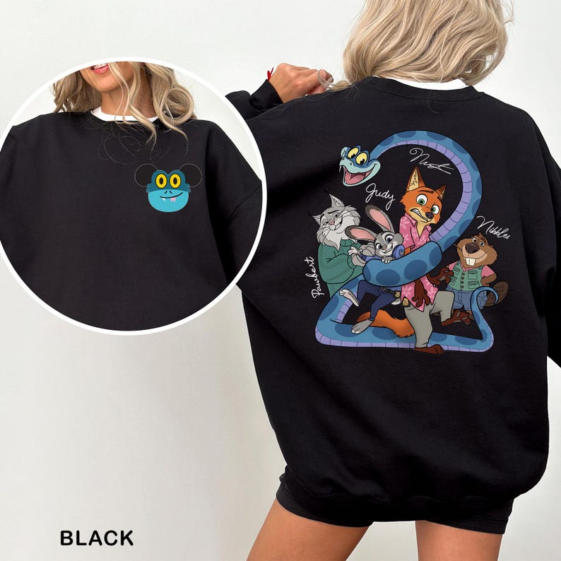 May include: Black sweatshirt featuring a cartoon design on the front and back. The front has a blue and yellow cartoon character. The back has a blue snake with cartoon characters and the names Judy, Nick, and Nibbles.