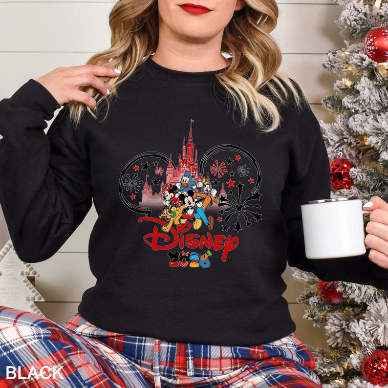 May include: Black crew neck sweatshirt featuring a Disney design with Mickey Mouse, Donald Duck, and other characters in front of a castle. The word "Disney" is in red script, with "2020" below. The word "BLACK" is at the bottom.