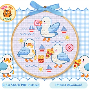 May include: A cross-stitch pattern featuring three cartoon seagulls with food items like donuts and pizza, surrounded by sailboats and suns. The design is set in a wooden hoop with a blue ribbon, on a blue and white checkered background.