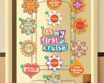 May include: A wooden door decorated with colorful welcome signs in various languages. The signs include phrases like "Welcome," "Benvenuti," and "It's my first cruise!" in a variety of shapes and colors.