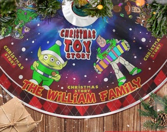 May include: A Christmas tree skirt featuring characters from Toy Story. The design includes Buzz Lightyear, an alien, and the text "Christmas Toy Story" and "The William Family" on a blue and red background.