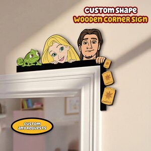 May include: A wooden corner sign featuring characters from a fairytale. The sign includes a green chameleon, a blonde woman, and a man. The sign also has three hanging lanterns. The text "CUSTOM SHAPE WOODEN CORNER SIGN" is displayed at the top.