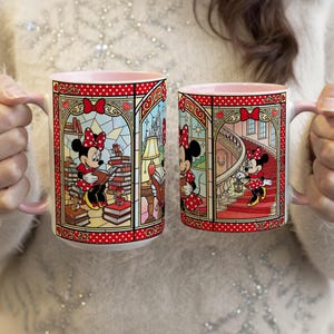 Puede incluir: Dos tazas de cer&aacute;mica con interiores y asas rosas. Cada taza presenta un dise&ntilde;o de estilo vidriera con Minnie Mouse con un vestido de lunares rojos. Una taza muestra a Minnie leyendo, la otra la muestra subiendo escaleras. Las tazas tienen un borde rojo punteado.