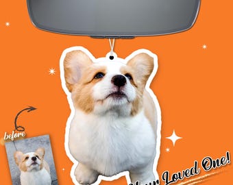 May include: A car air freshener featuring a corgi dog with white, tan, and brown fur. The air freshener is hanging from a car's rearview mirror. The words "Your Loved One!" are written on the bottom right.