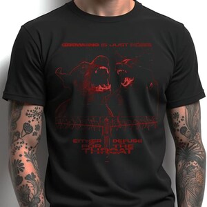 May include: Black t-shirt featuring a red graphic design of two snarling dogs with the text "GROWING IS JUST NOISE" and "EITHER DEFUSE FOR THE THROAT".