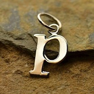 May include: Silver charm in the shape of the letter P.