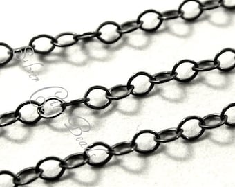 May include: A close-up image of black chain link, a type of jewellery finding. The chain is made of metal and has a smooth, polished finish.
