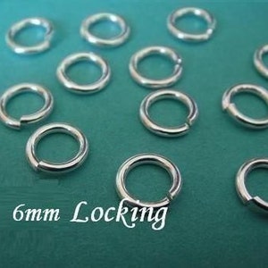 May include: A close-up of 10 silver 6mm locking jump rings. The rings are arranged in a random pattern on a turquoise surface.