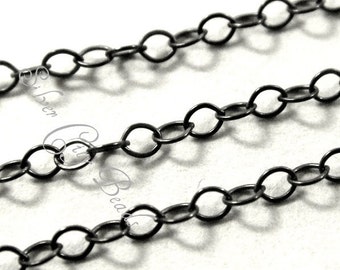 May include: A close-up image of black chain link, a type of jewellery finding. The chain is made of metal and has a smooth, polished finish.