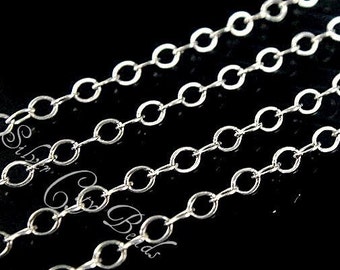 May include: Silver chain with a delicate, oval link design. The chain is shown in multiple strands, highlighting its fine detail.