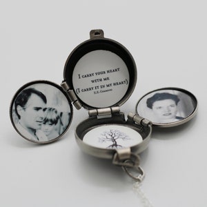 May include: A silver locket necklace with a hinged lid. The locket is open, revealing a black and white photo of a man and a child. The other side of the locket has a black and white photo of a woman. The locket has a quote inside: "I carry your heart with me (I carry it in my heart) E.E. Cummings".
