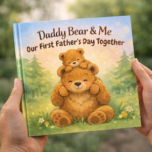 May include: A children's book titled "Daddy Bear & Me Our First Father's Day Together" features a watercolor illustration of a bear and cub. The cover art depicts a smiling bear with a smaller bear cub on its head, set against a backdrop of a forest scene.