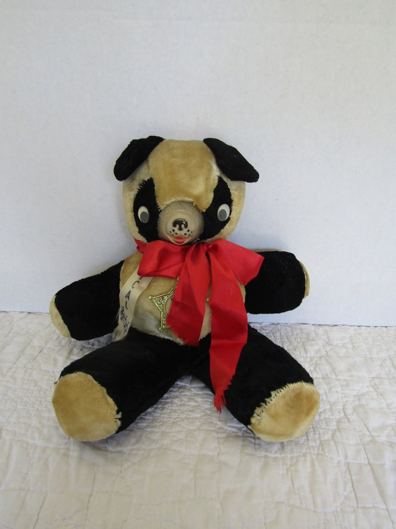 Vintage Stuffed Bear Musical Large with a badge reading Savings Institute