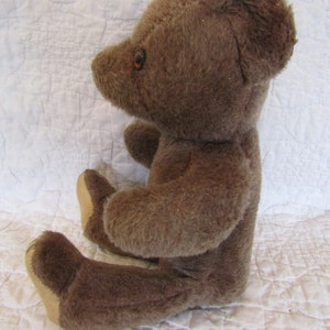 vintage teddy bear with bell in ear