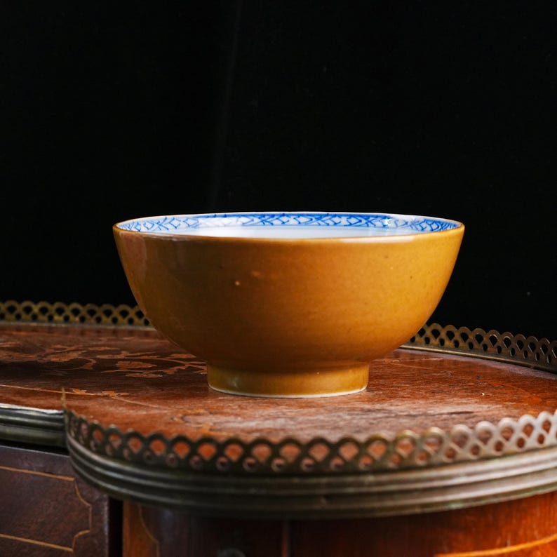 May include: A set of three ceramic mugs with a speckled, matte finish. The mugs are in shades of cream, light gray, and dark gray. Each mug has a simple, modern design and a rounded handle.