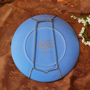 May include: A blue commemorative plate with a wire plate hanger. The plate has text that reads "To commemorate the visit of Queen Elizabeth Ottawa during the Silver Jubilee Year 1977". Limited edition.