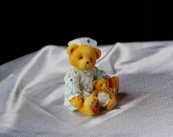 Vintage Cherished Teddies “Laura - Friendship Makes It All Better” Nurse Bear Figurine, 1996 Priscilla Hillman Design Nurturing bond Friend