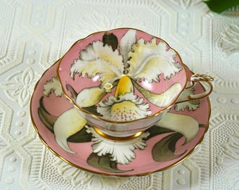 Zeldzame antieke Paragon "Double Warrant" bone China theekop en schotel, volledige dekking witte orchidee op roze ondergrond, handgeschilderd, Engeland jaren 1930