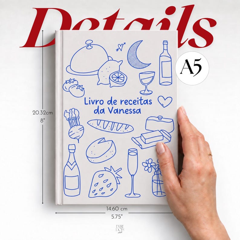 May include: A white A5 recipe book titled Livro de receitas da Vanessa with blue line art illustrations of food, drinks, and a crescent moon. The book measures 8 inches by 5.75 inches, featuring a hard cover with a clean, minimalist design.
