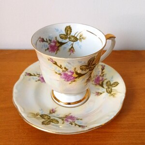 Beautiful Chodziez cup and saucer with flower decor and iridescent glaze