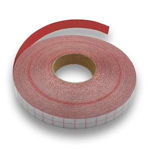 May include: A roll of red abrasive tape, unwound to show the abrasive side. The tape is wound around a cardboard core. The backing is white with a red grid pattern. The tape is used for sanding and finishing.