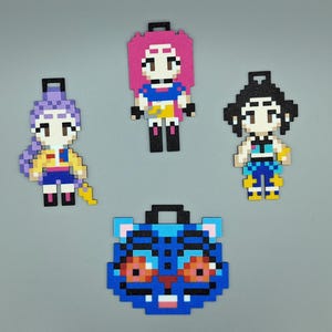 May include: Four pixel art-style character and animal designs. The characters have various hair colours and outfits. The animal is a blue tiger face. Each design has a black loop at the top.