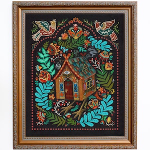 May include: A framed folk art print featuring a whimsical house with chicken feet, surrounded by colorful floral and bird motifs. The artwork has a dark background and a decorative gold frame, creating a vibrant and detailed composition.