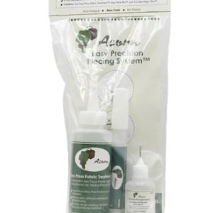 May include: A clear plastic bag containing three bottles of Acorn Precision Piecing products. The bottles have green and white labels with text and a logo. The kit includes Easy Press Fabric Treatment and a needle-tipped bottle.