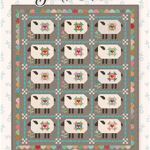 May include: A patchwork quilt with a repeating pattern of sheep, each with a heart-shaped design. The quilt has a grey background with a teal border and the words "Gentle Flock" at the top. Designed by Lori Holt.